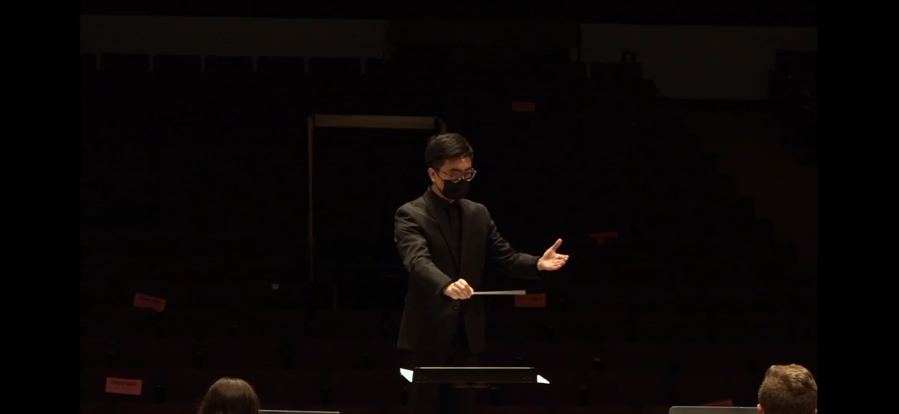 Yi Tang conducting a band at the University of Minnesota